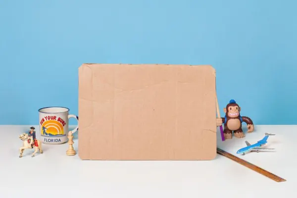 Cardboard laptop stand-in beside a Freddie figure on blue