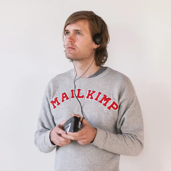 Man in headphones wearing a Mailkimp sweatshirt