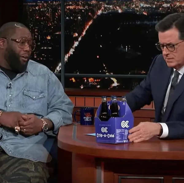 Killer Mike on a late-night talk show set beside a box bearing his logo